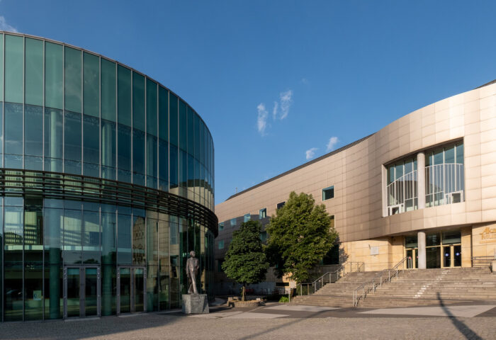 Zdjęcie przedstawia główne wejście do Akademii Muzycznej w Poznaniu i może zachęcać do odwiedzenia uczelni