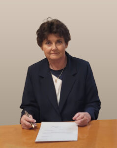 Hanna Kostrzewska. Zdjęcie przedstawia kobietę przy biurku