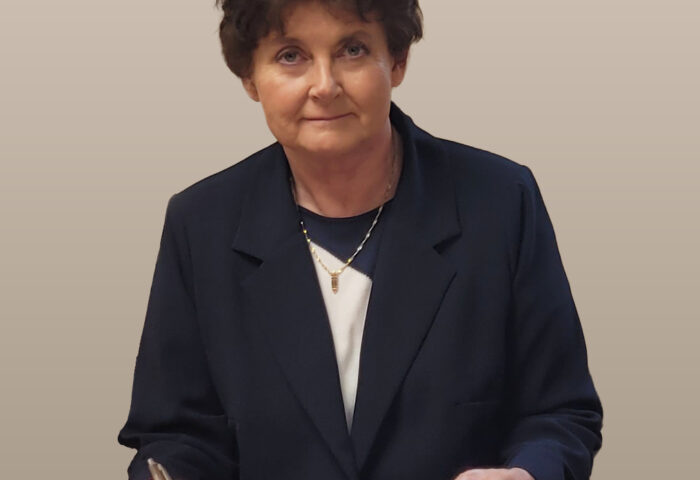 Hanna Kostrzewska. Zdjęcie przedstawia kobietę przy biurku